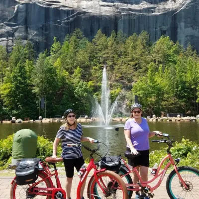 a person riding a bicycle in front of a lake