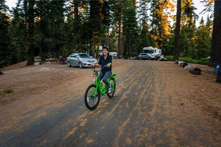 a man riding a bike down a dirt road